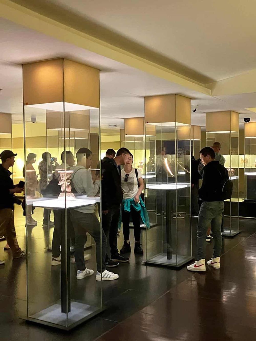 Visitors exploring collectibles at QuestForDirections museum, showcasing innovative ways to find directions.