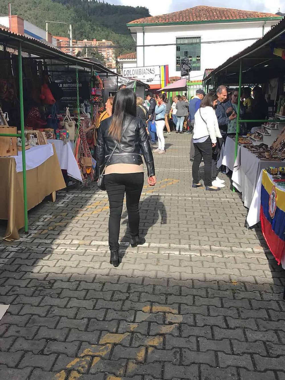 Colorful outdoor market in Colombia showcasing diverse local crafts and vibrant culture.