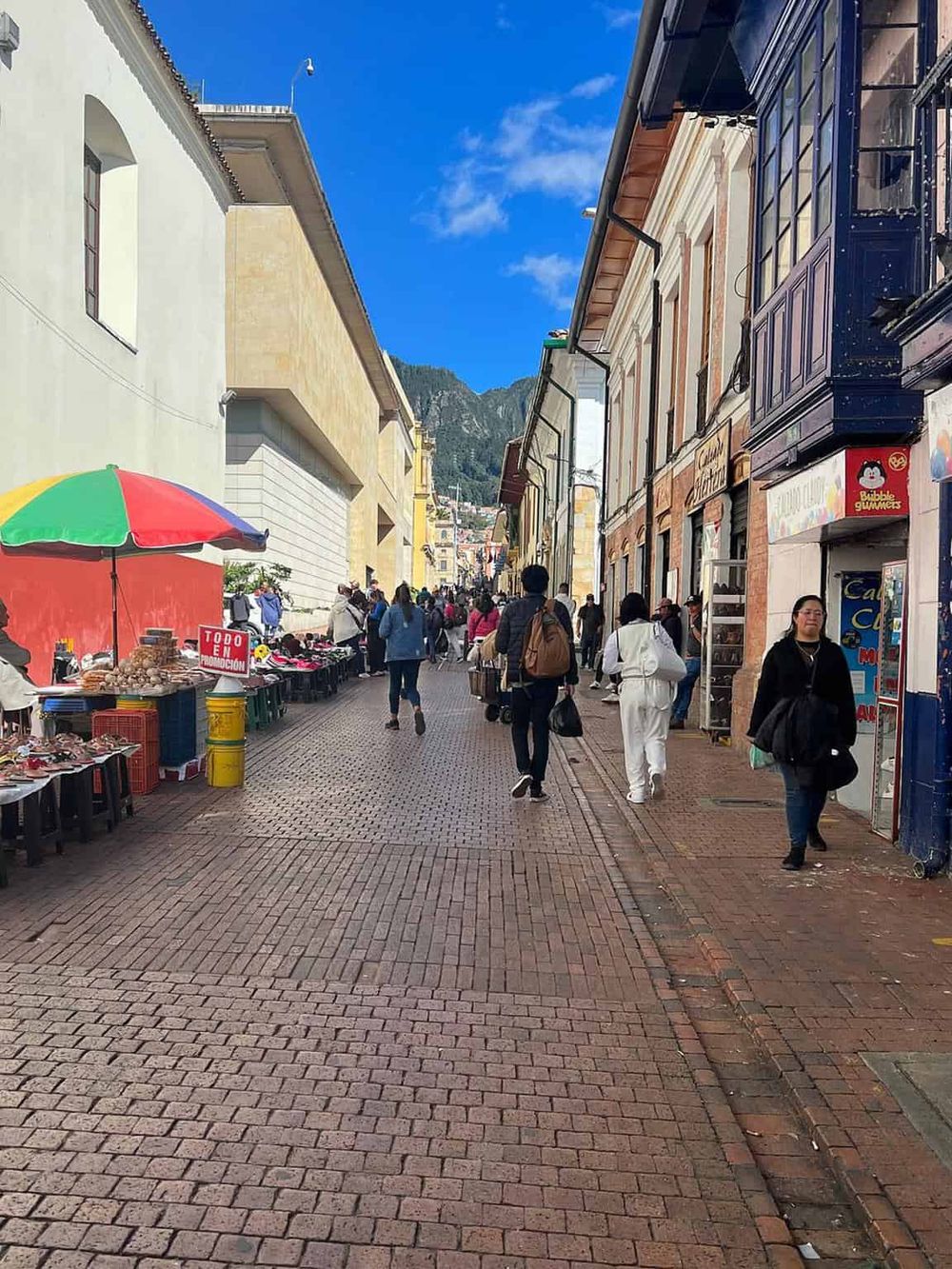 Vibrant street scene in Guanajuato, Mexico with colorful buildings, street vendors, and tourists exploring historic downtown.