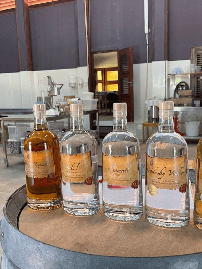 Aged spirits bottled on a barrel, showcasing traditional distillation and craft alcohol production.