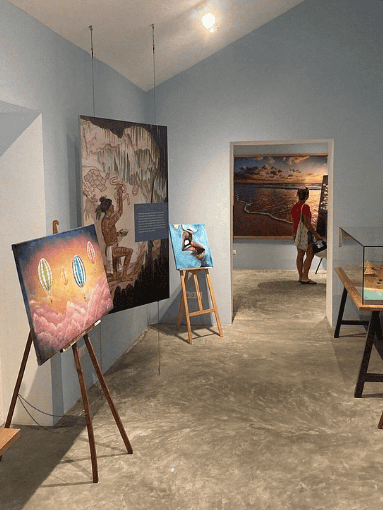Colorful art gallery exhibit showcasing paintings and photography at QuestForDirections.