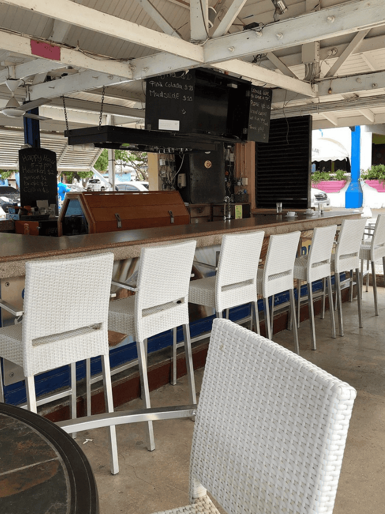 Comfortable bar with white wicker chairs at QuestForDirections restaurant.