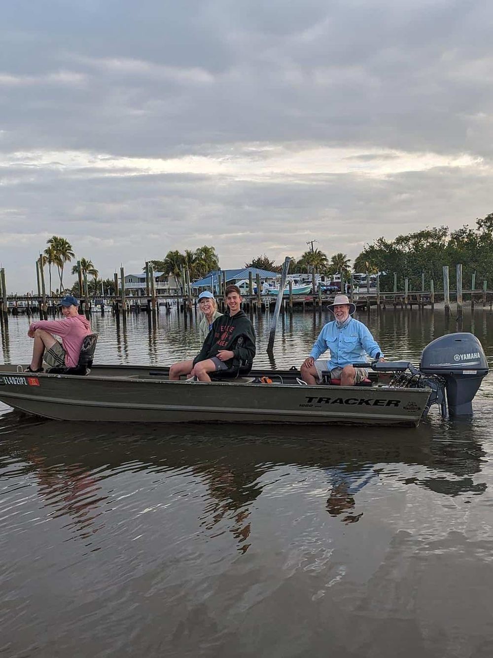 Relaxing boat ride in a Florida canal with family, scenic waterway and dockside houses, enjoying outdoor adventure.
