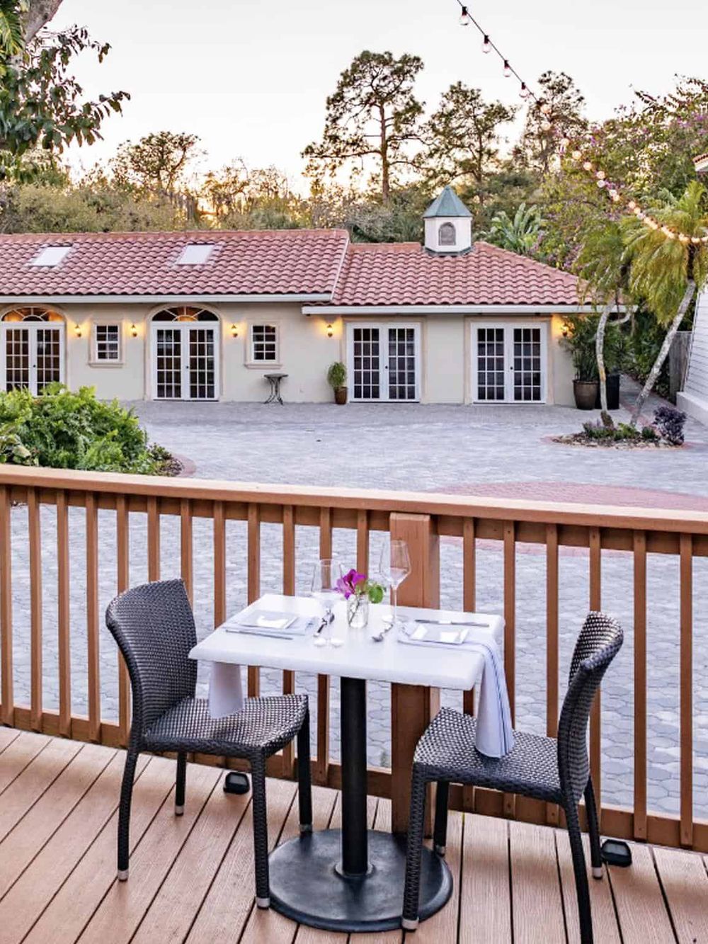 - Cozy outdoor dining area with scenic view of a charming house and lush surroundings.