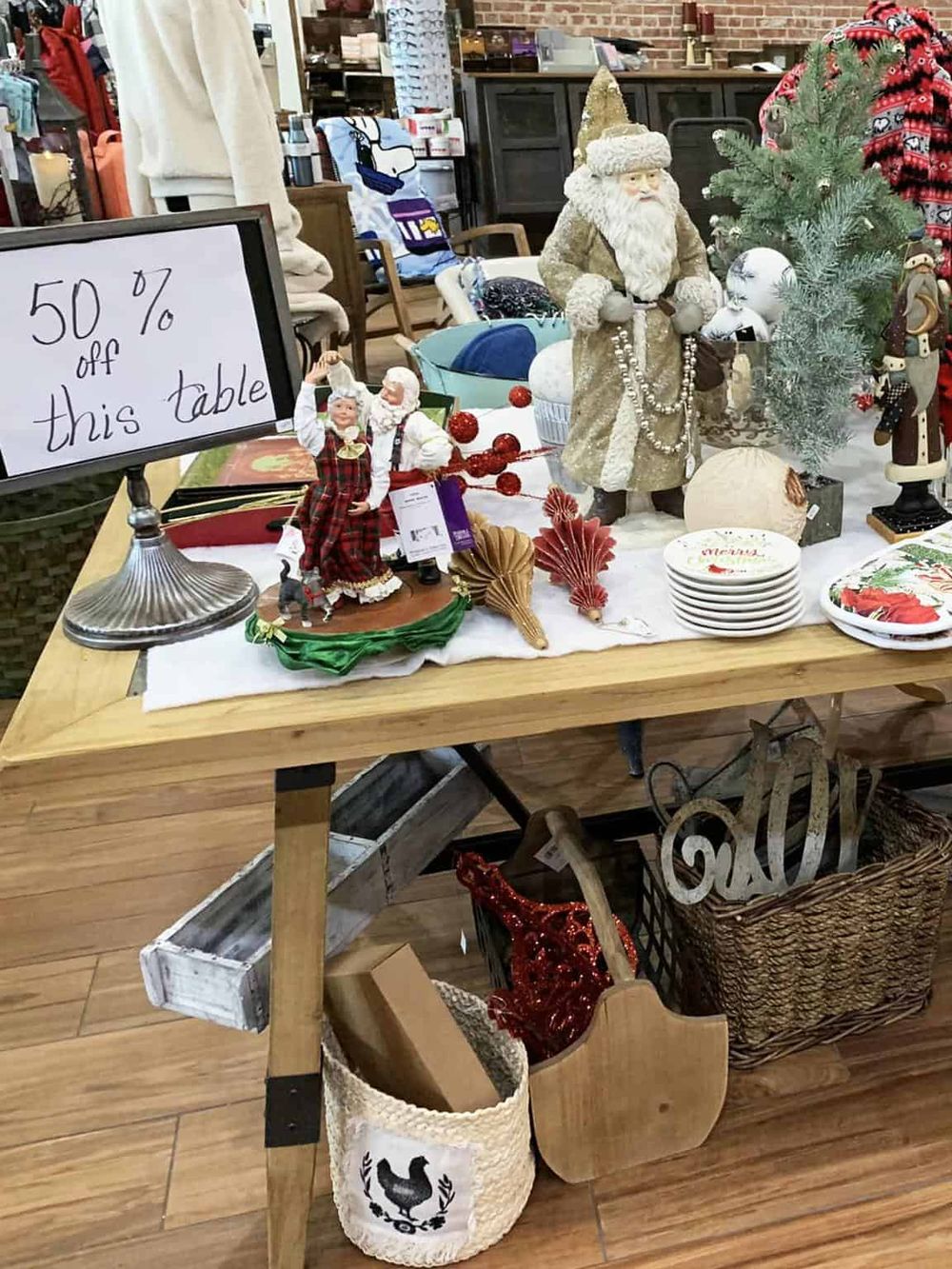 Festive holiday table with Christmas decorations, Santa figurines, and seasonal tableware.