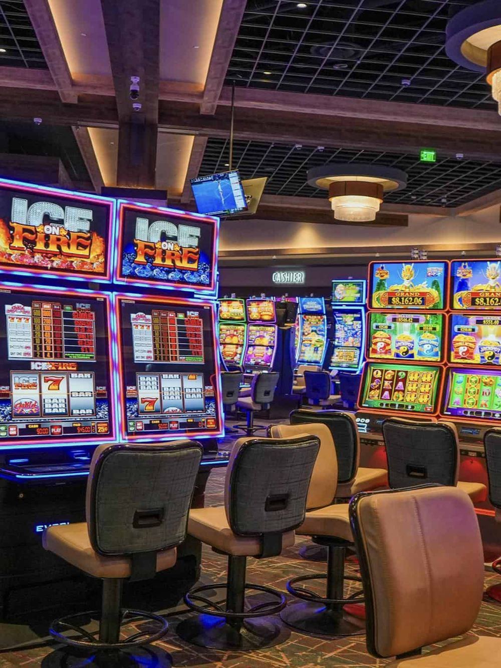 Vibrant casino gaming area with colorful slot machines and neon lights, perfect for entertainment and gaming enthusiasts.