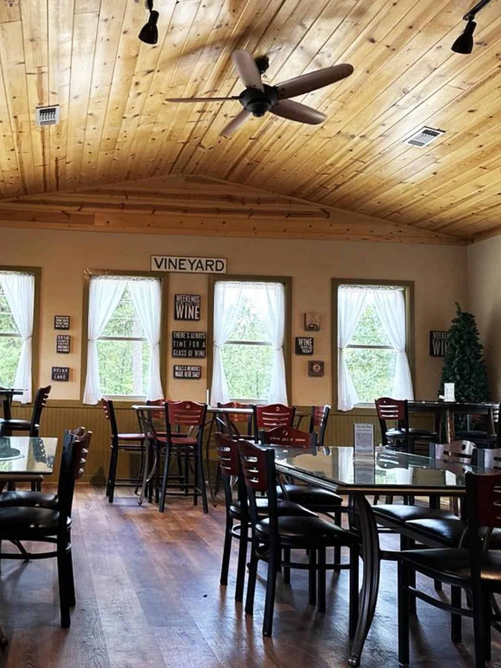 Cozy winery restaurant interior with wooden ceiling and elegant decor, perfect for wine tasting and vineyard dining experiences.