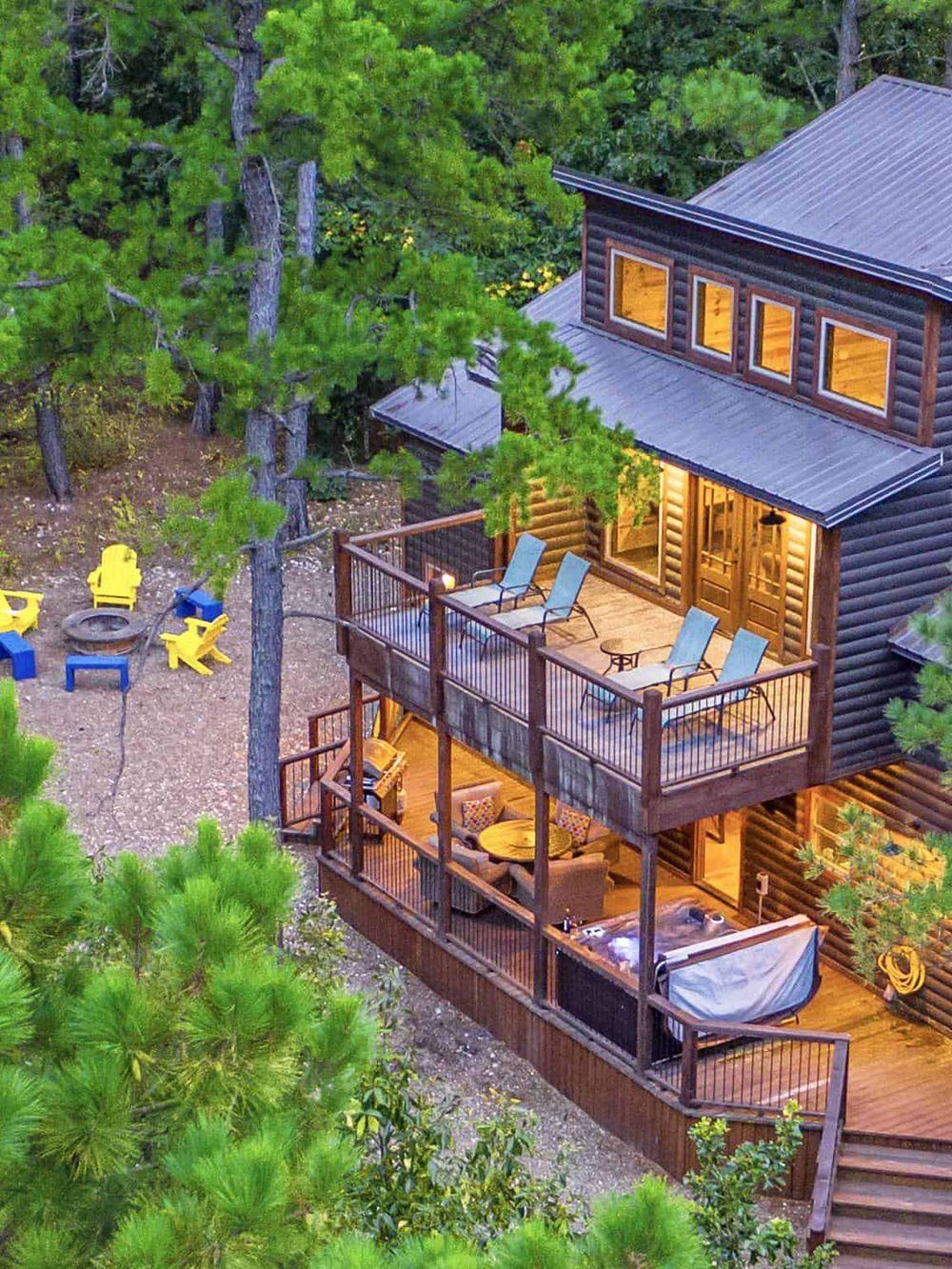 Cozy cabin with wooden decks surrounded by lush pine trees, ideal for outdoor relaxation and nature adventures.