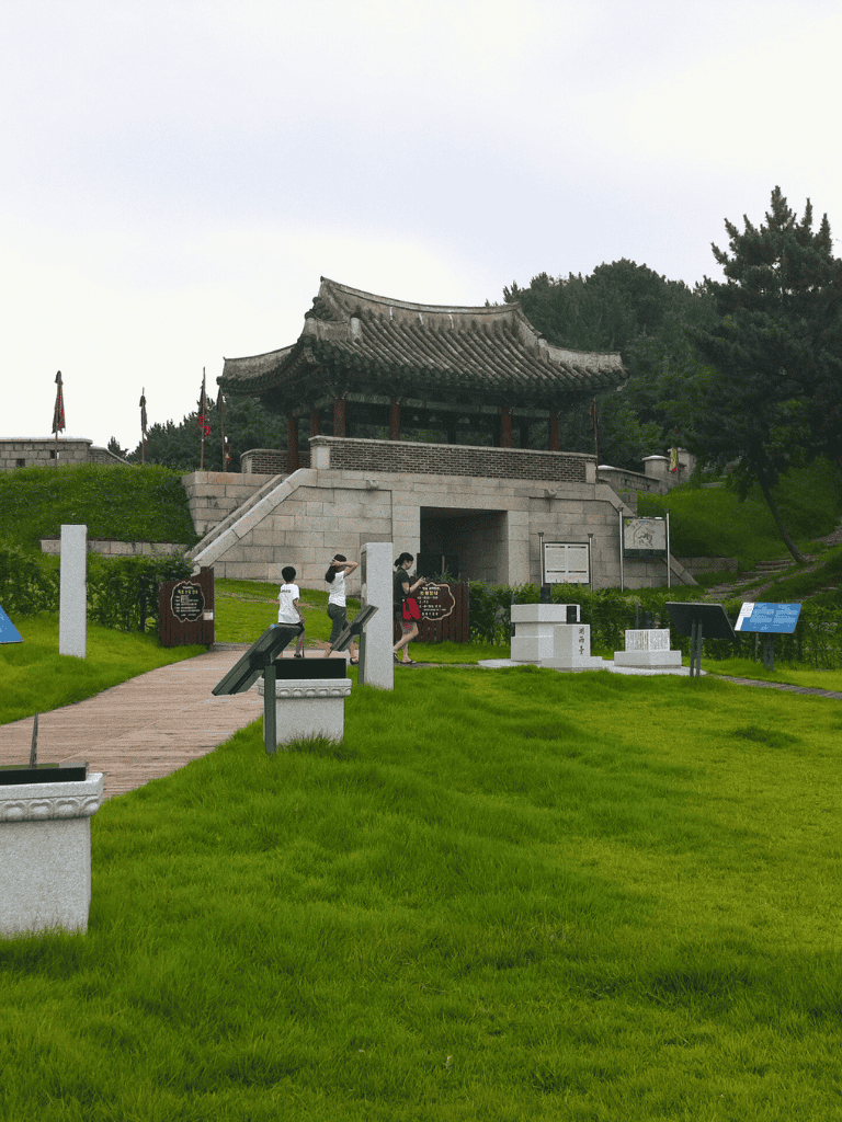 Ancient Chinese pavilion at Quest for Directions site in Seoul, surrounded by lush greenery.