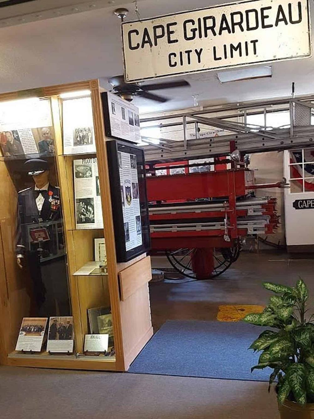 Vintage Cape Girardeau city limit sign and historical museum display with firefighter memorabilia.