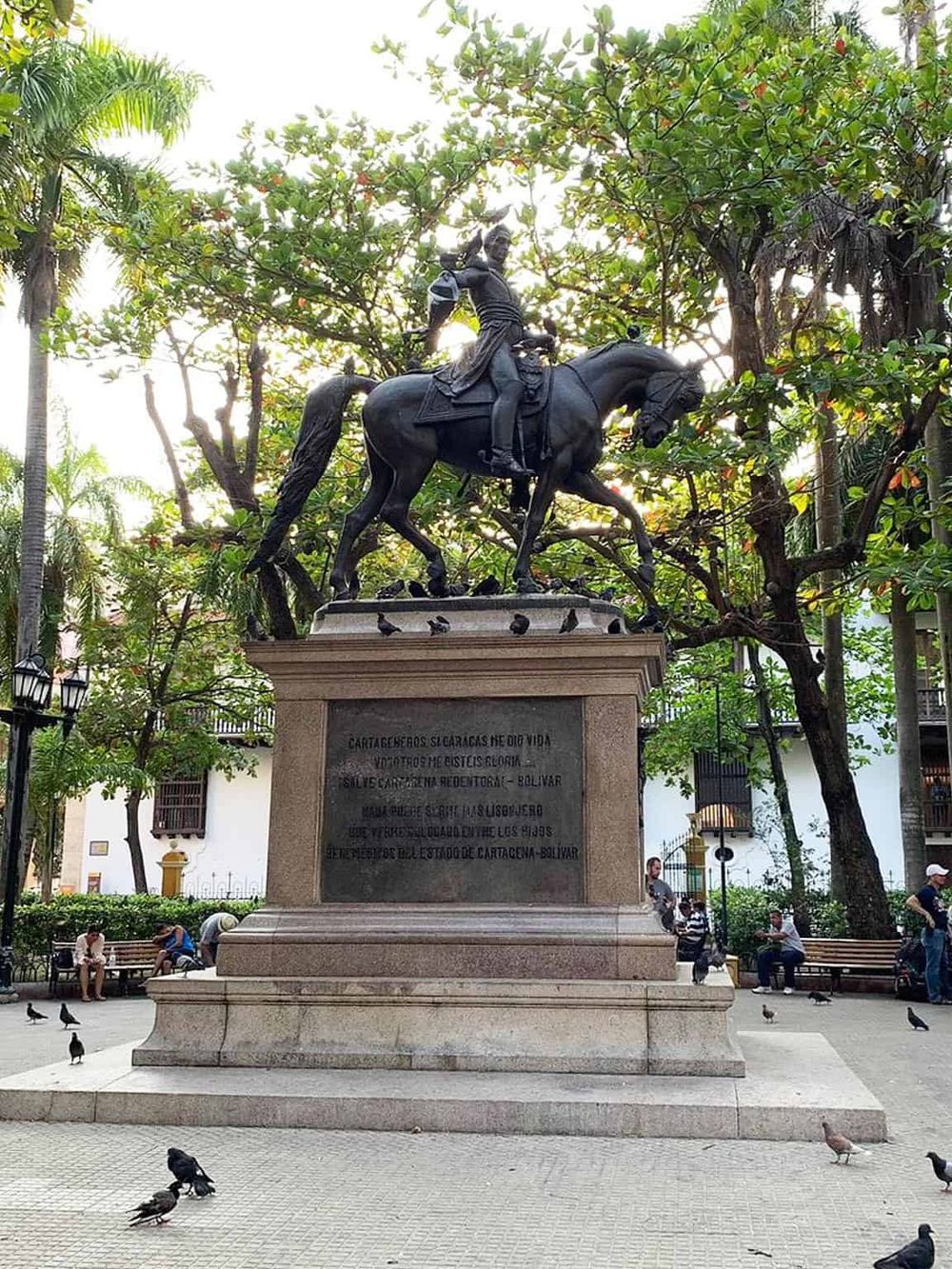 Bronze statue of a mounted soldier honoring Cartagena’s historical roots, located in a lush city park.