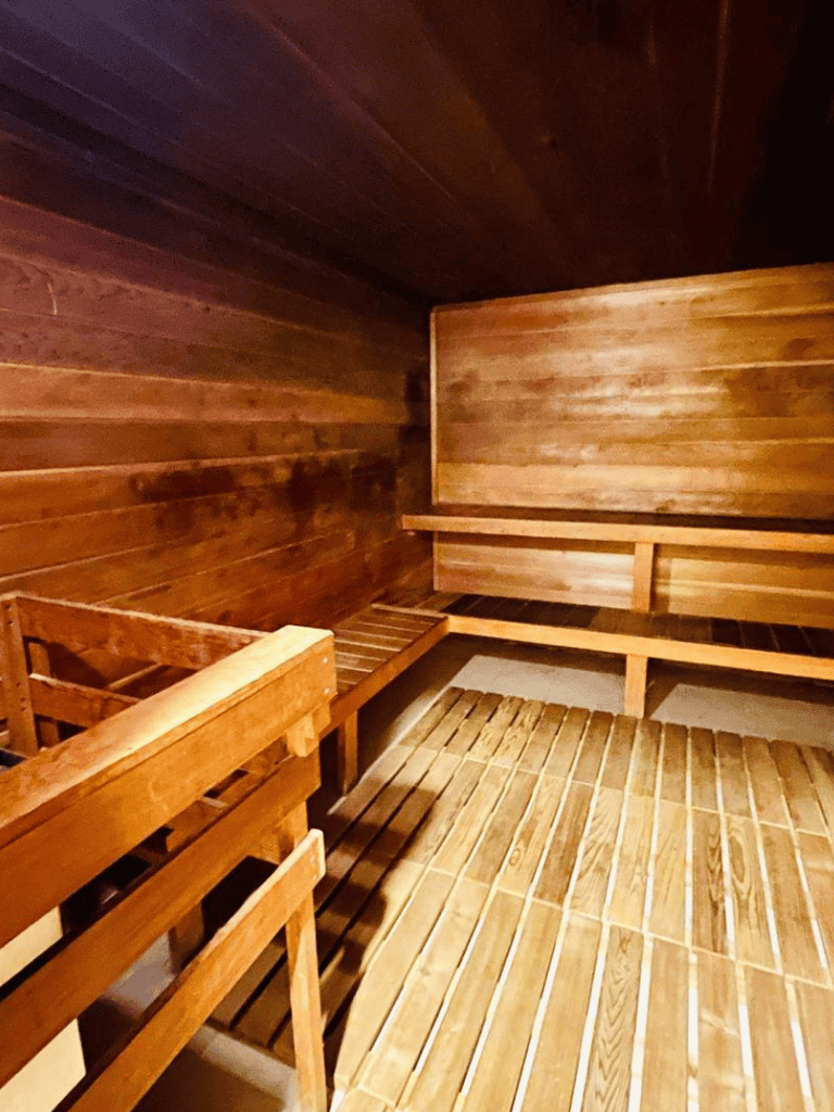 Sauna room with wooden benches for relaxing and wellness. Perfect for relaxation after fitness or spa sessions.