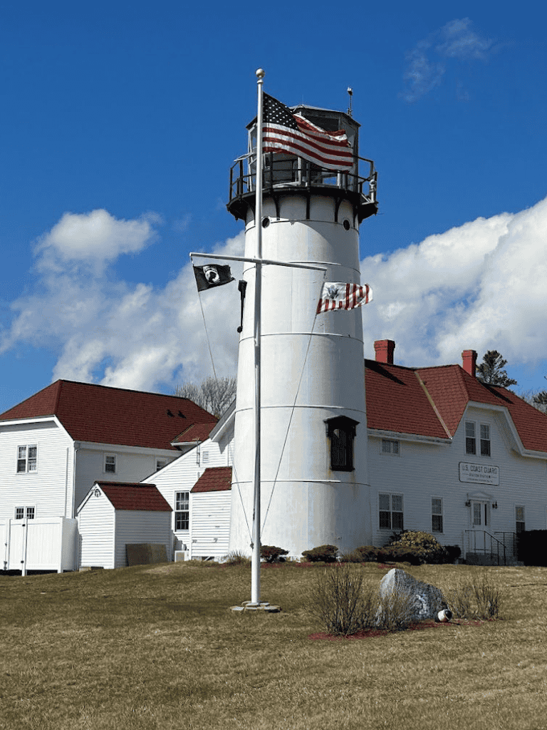 Vintage lighthouse with American flags at quest for directions.