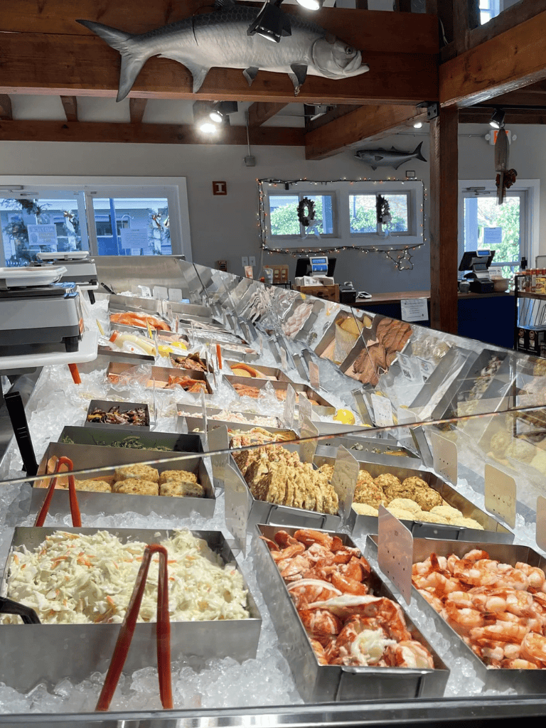 Fresh seafood display at QuestForDirections, featuring crab, shrimp, and fish on ice.