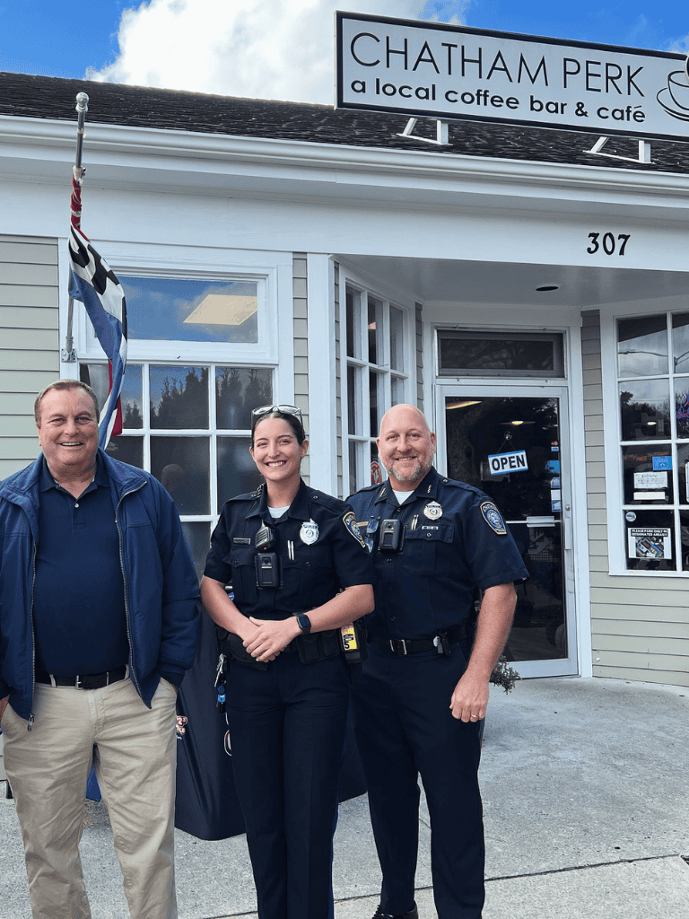 Accessible coffee shop with police officers in front, friendly community atmosphere.