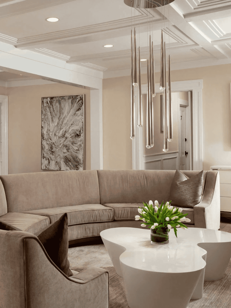 Luxurious living room interior with modern chandelier, plush beige sofa, and elegant decor, perfect for upscale home design.