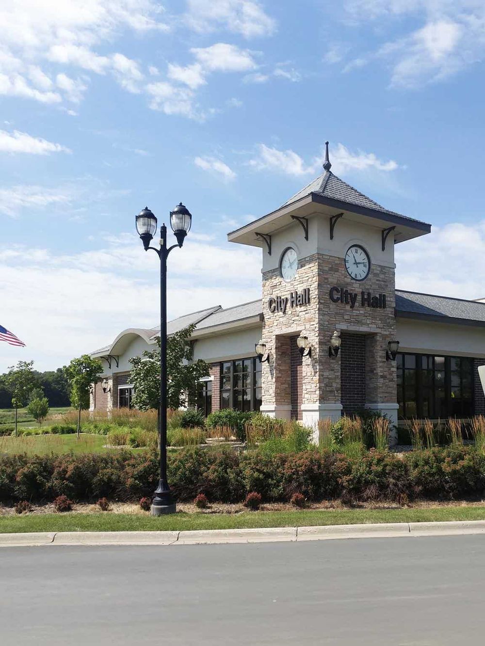 Stunning city hall building with clock tower and landscaped surroundings, perfect for local government and community events.