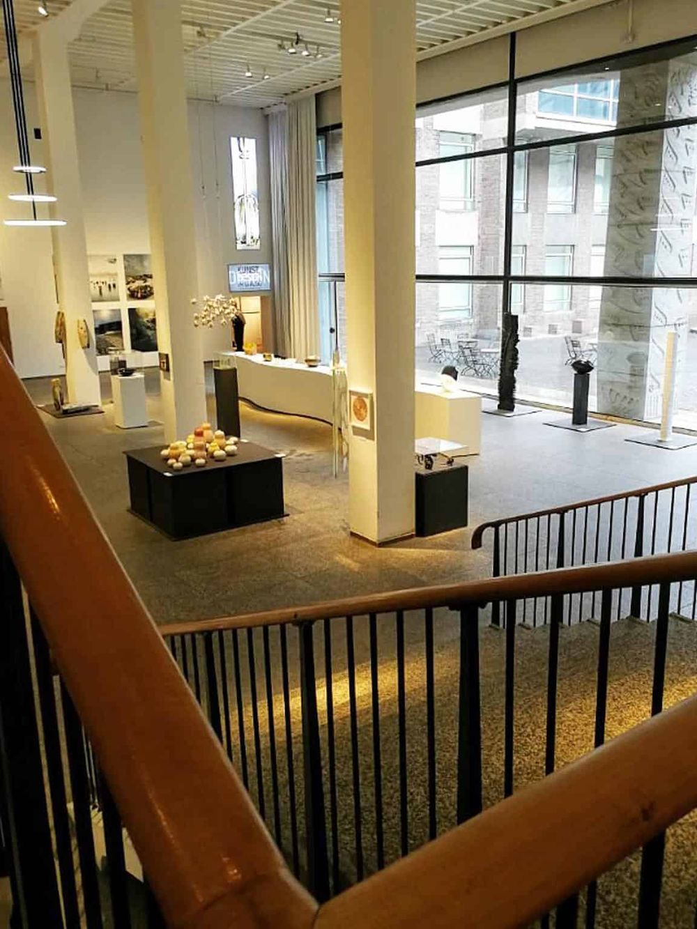 Modern hotel lobby with large glass windows, stylish decor, and welcoming atmosphere for travelers.