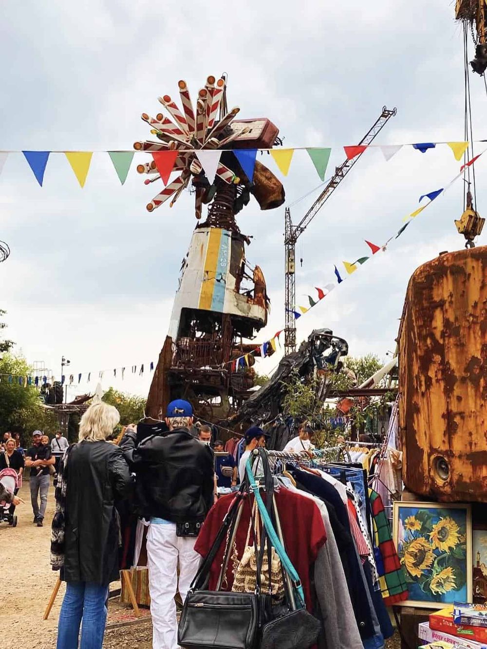 Colorful vintage amusement park ride with people shopping at outdoor fair, sunny day, tropical decor, QuestForDirections promotional image.