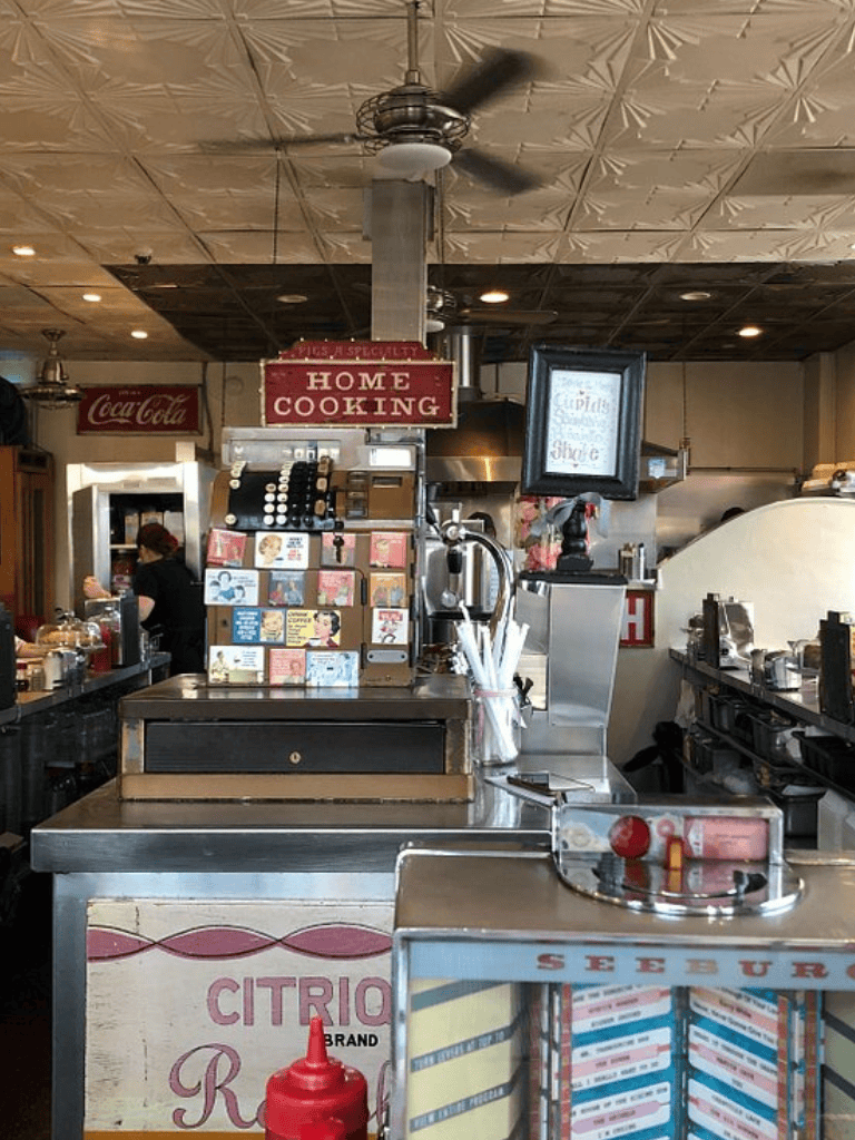 Fresh diner counter with vintage decor and home-cooking signage at QuestForDirections restaurant.