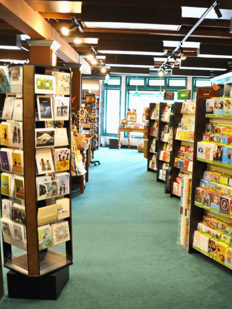 Bright bookstore interior with colorful children’s books and travel guides, inviting family-friendly reading and learning experiences.