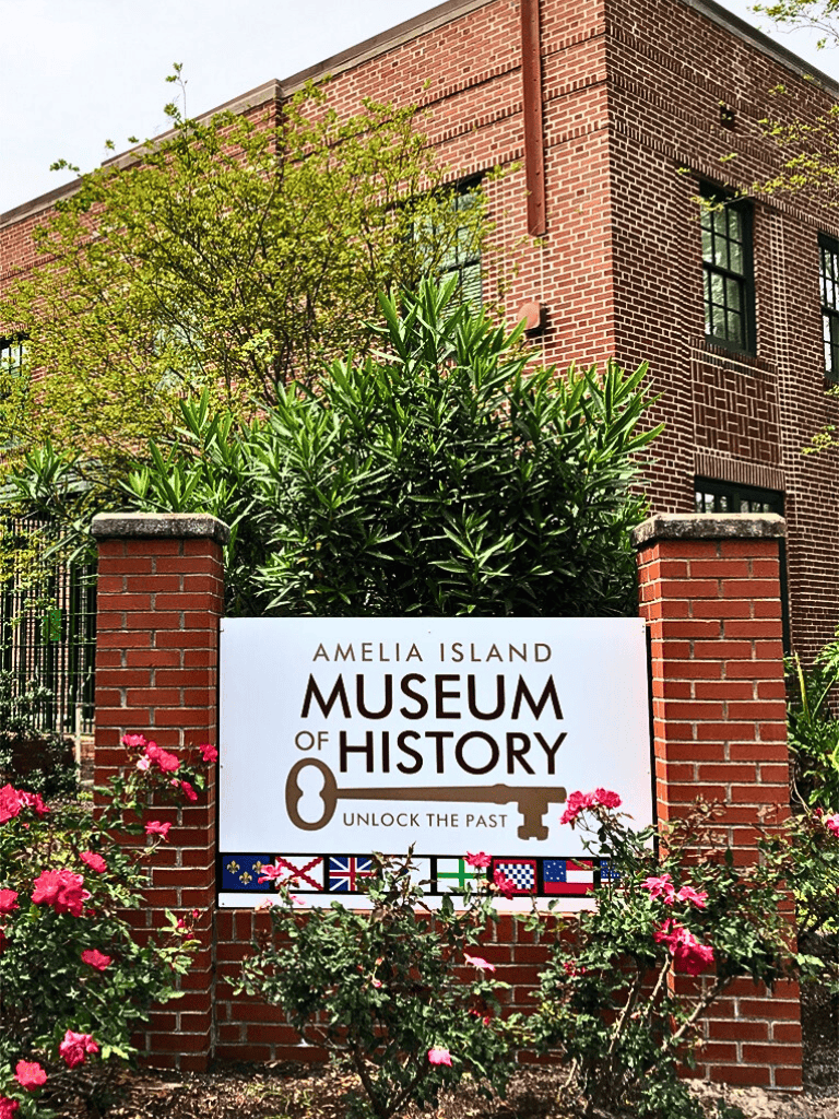 Historic brick building with lush greenery at Amelia Island Museum of History, Florida.