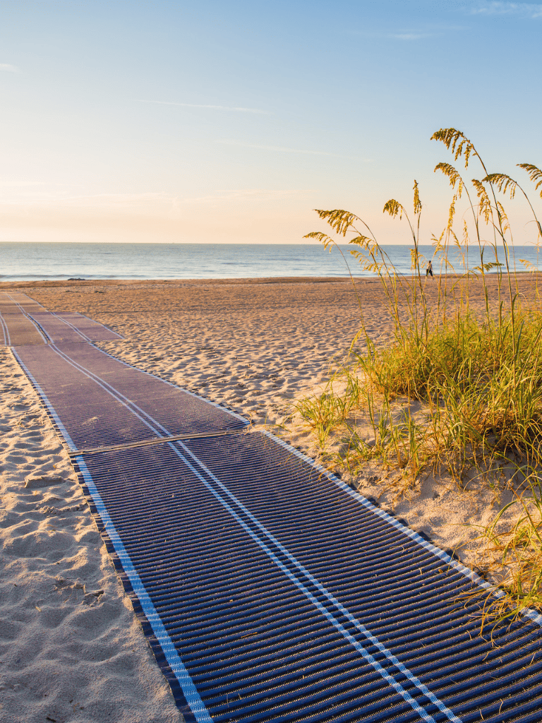 Beach pathway to ocean at sunset, relaxing seaside destination, coastal walk, scenic beach view, summer vacation spot, QuestForDirections.