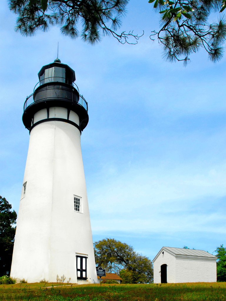 Historic lighthouse with scenic coastal views and bright white exterior.