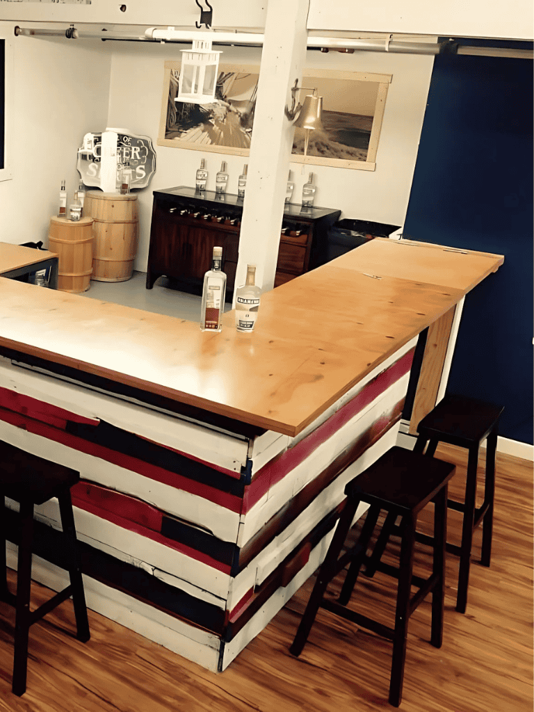 Smooth whiskey bottles on wooden table with bar décor, artwork, and bar stools in cozy settings.