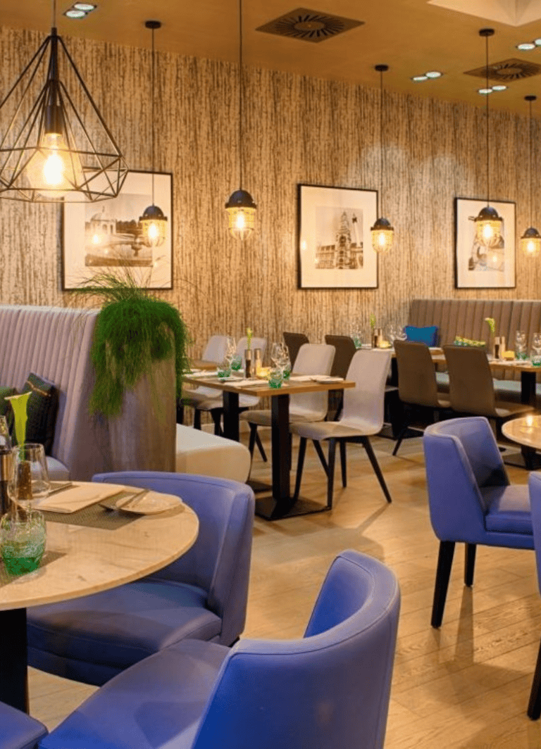 Elegant restaurant interior with modern decor and ambient lighting, ideal for dining and socializing.