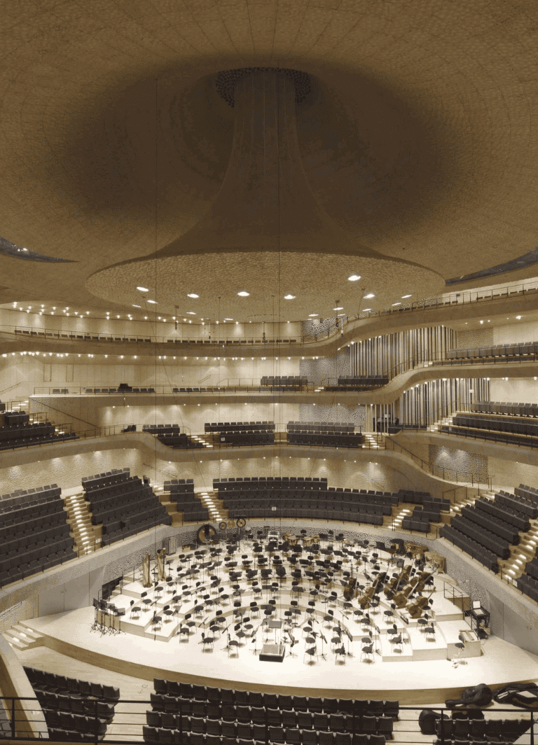 Modern concert hall interior with stage and seating for live music performances.