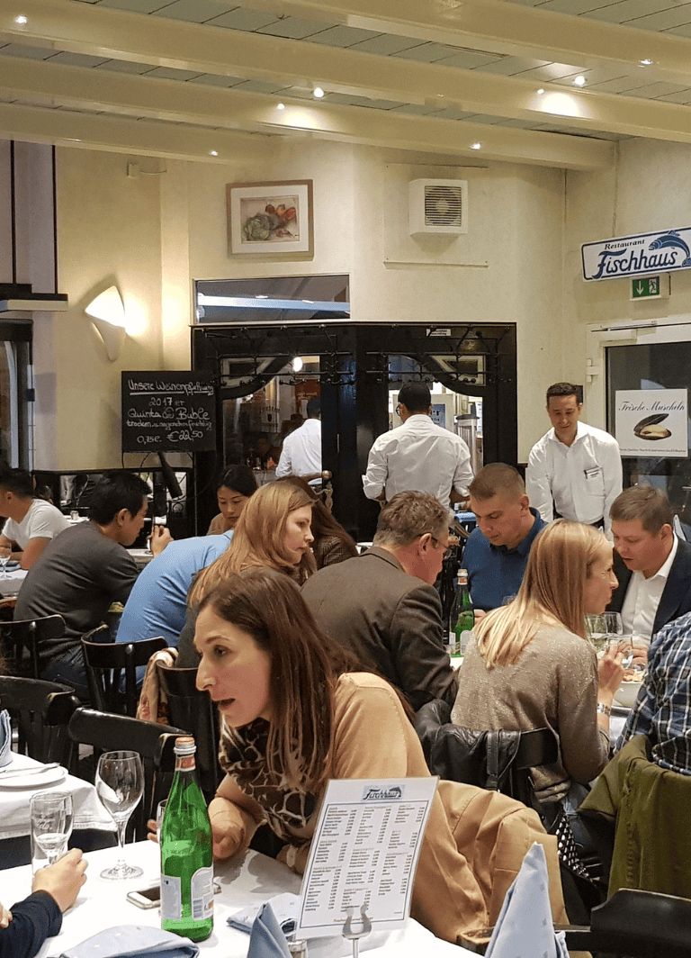 Cozy restaurant interior with diners enjoying meals, perfect for family and group dining experiences.