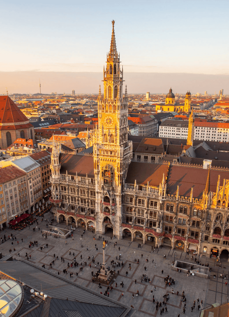 Iconic Munich City Hall with Gothic architecture and vibrant city views at sunset.