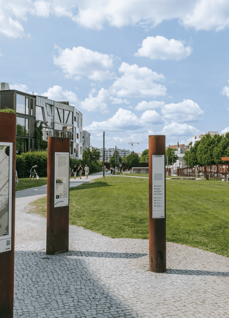 Aerial view of urban park with modern architecture, pathways, and people, showcasing QuestForDirections' outdoor navigation solutions.
