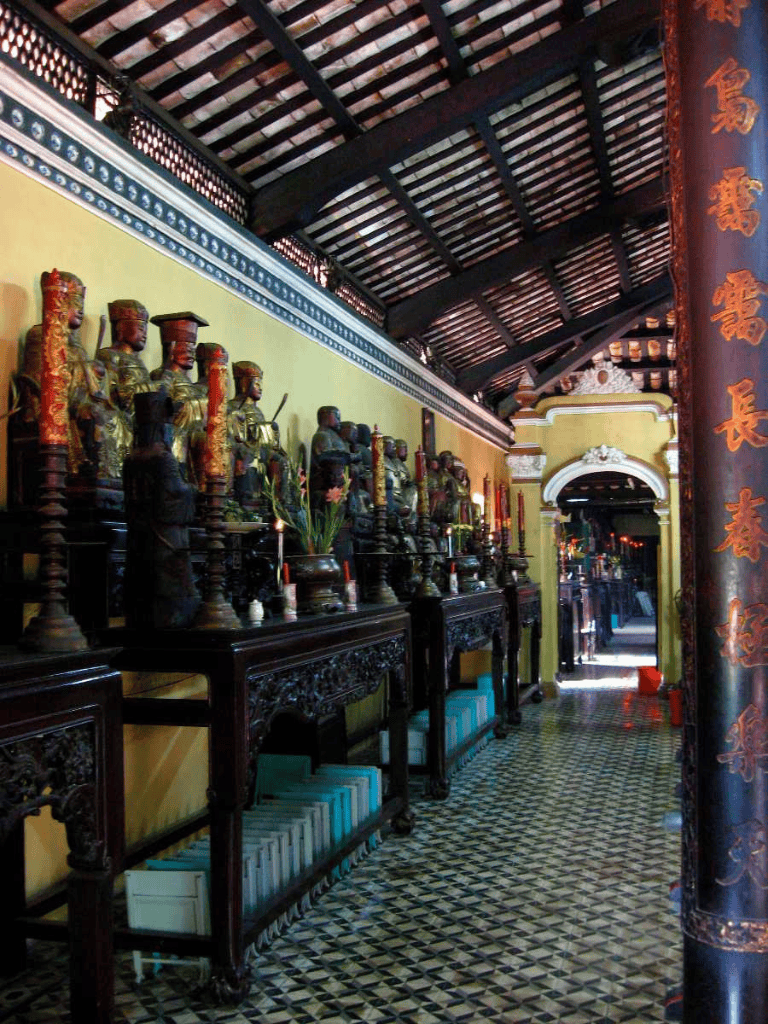 Ancient Asian temple altar with statues and intricate woodwork, traditional décor, and sacred artifacts.