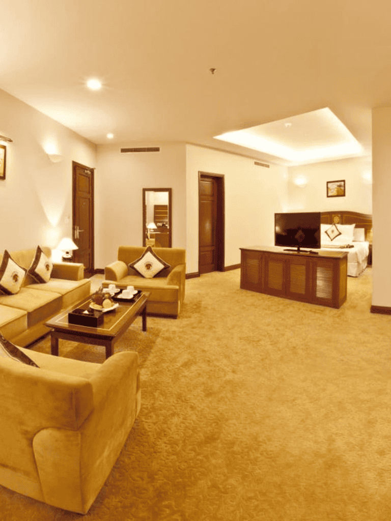 Luxury hotel suite with living area and bedroom, cozy and elegant interior design.
