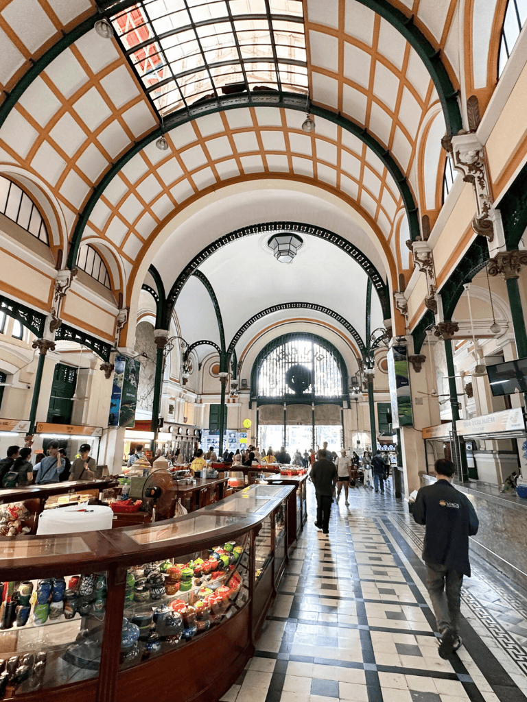 Intriguing interior of Quest for Directions historic marketplace with high arched ceilings and vibrant shopping atmosphere.
