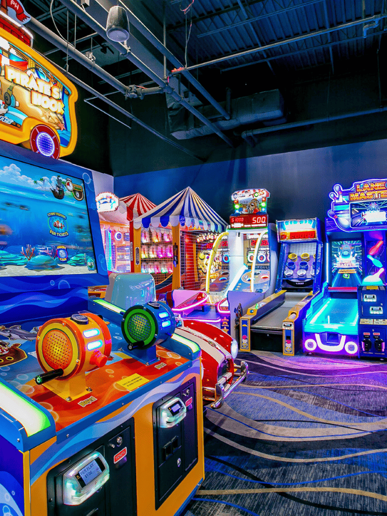 Colorful arcade games and claw machines at QuestForDirections amusement center, perfect for family entertainment.