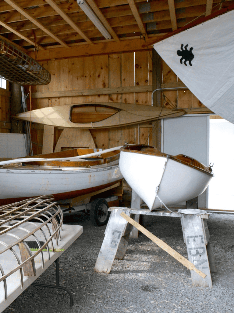 Wooden boat workshop with boat hulls and boat frames.