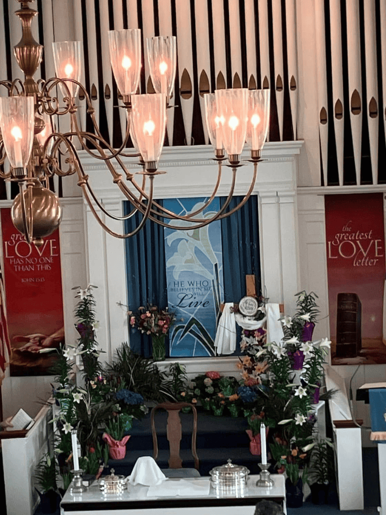 Resurrection church altar decorated with flowers and candles for service or event.