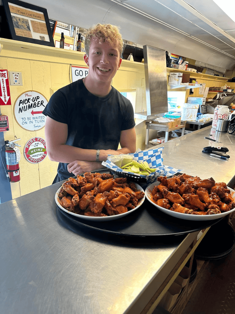 Crispy fried chicken wings served with pickles at QuestForDirections restaurant.