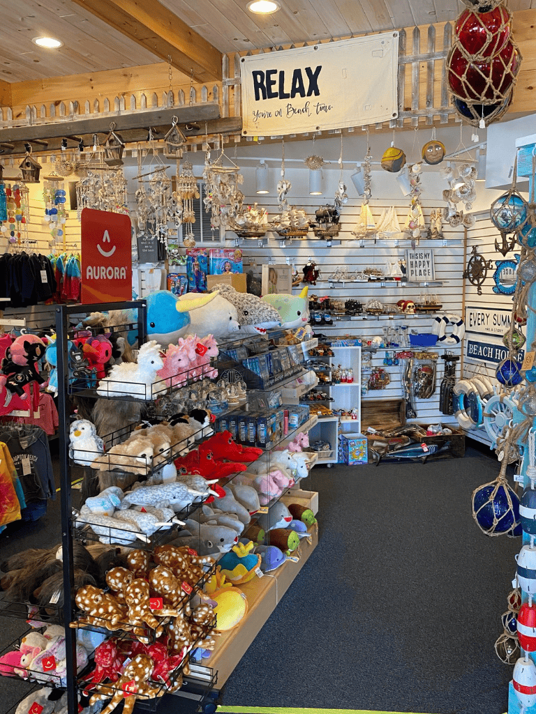 Colorful beach-themed souvenirs and toys at Quest for Directions store in a coastal gift shop.