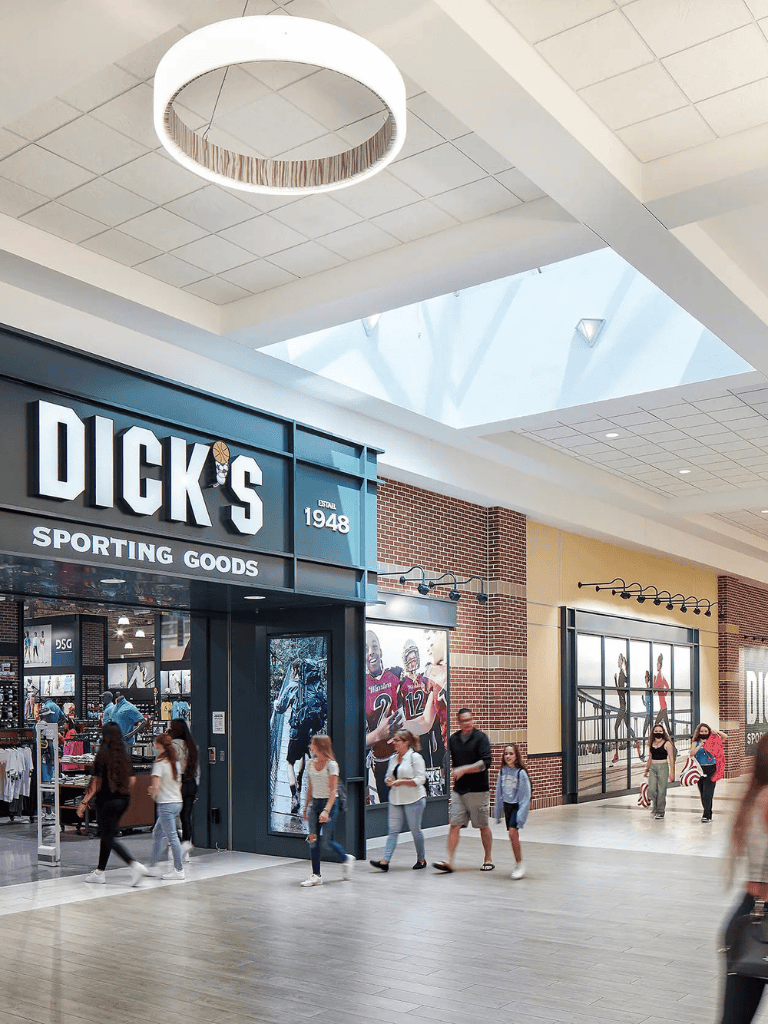 DICK'S Sporting Goods store entrance in shopping mall, modern retail, popular athletic gear retailer, shopping mall interior, retail store design.