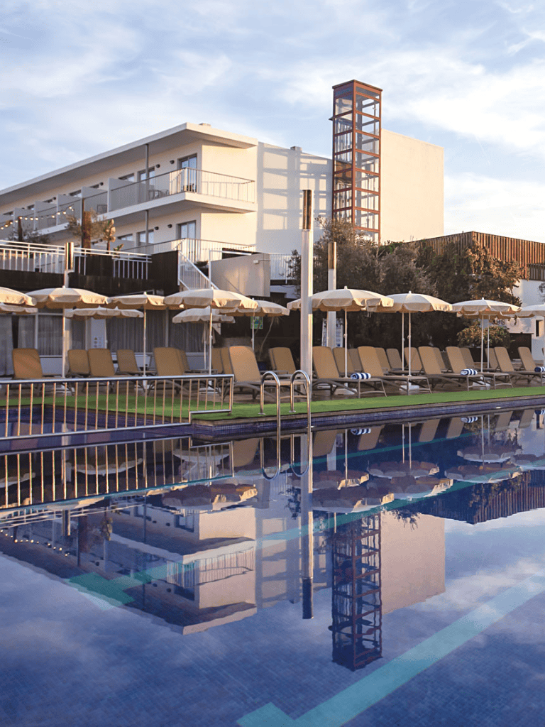 Modern hotel with poolside loungers and scenic architecture for a luxurious stay.