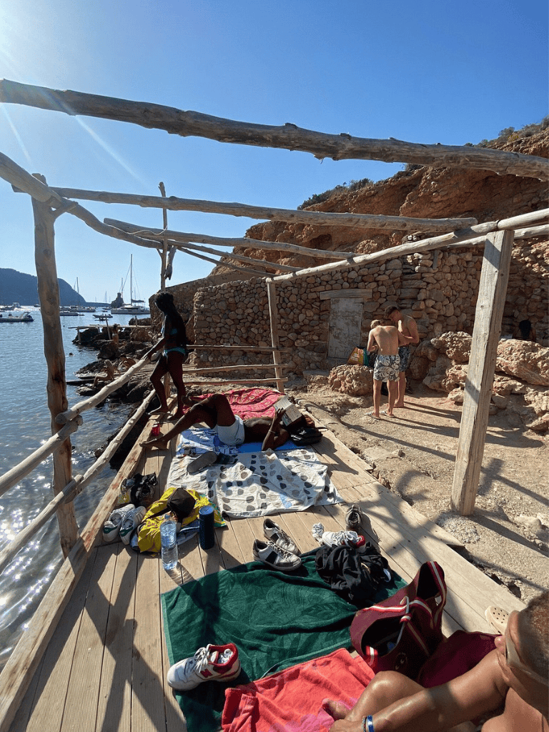 Relaxing seaside dock with boats and sunlit sky, perfect for vacation and travel adventures.