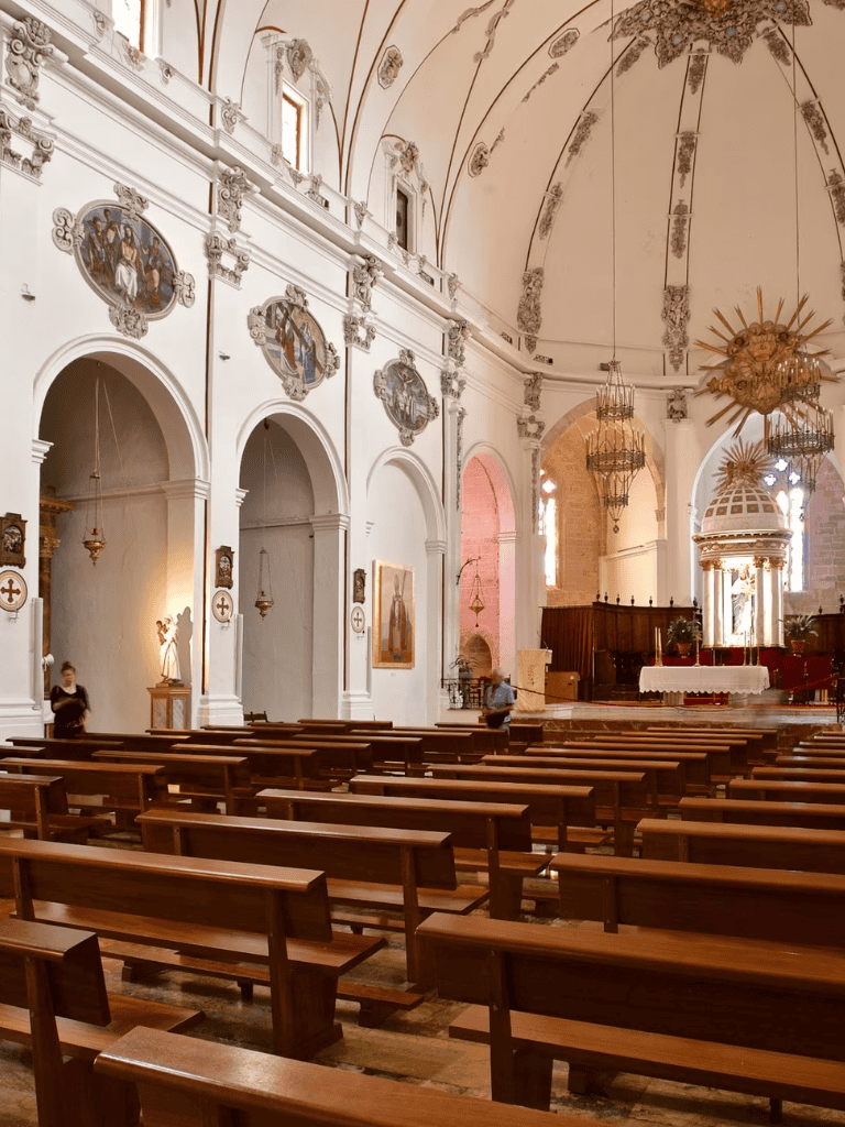 Serene church interior with religious artwork and wooden pews, perfect for spiritual reflection and prayer.