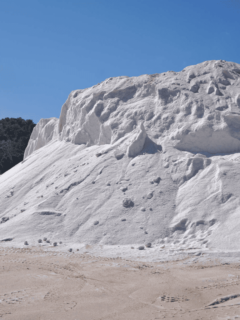 Snow-covered mountain peak with clear blue sky, scenic winter landscape, snow navigation, mountain adventure, travel destination.
