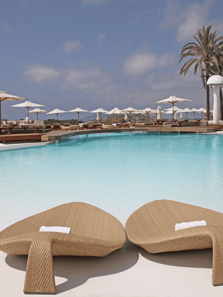 Relaxing poolside with lounge chairs and umbrellas at a luxury resort.
