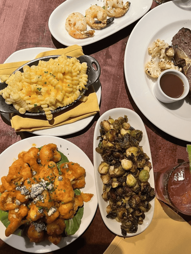 Creamy macaroni and cheese with herbs on a white plate, served at QuestForDirections restaurant.