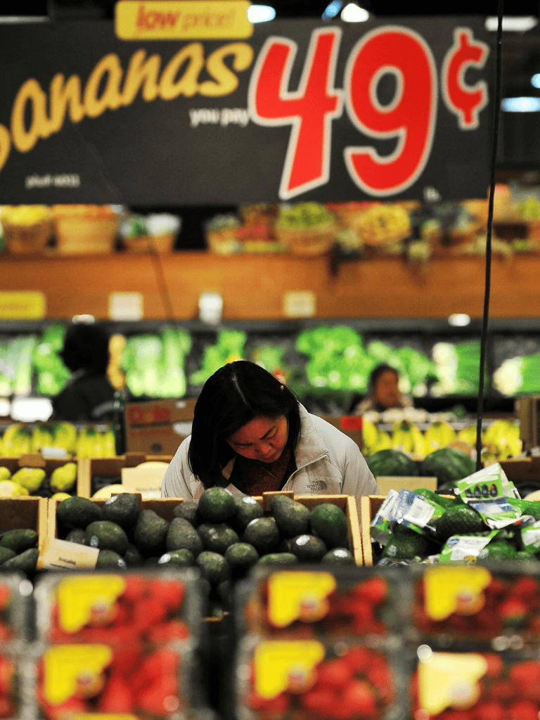 Fresh avocados on display at a grocery store.